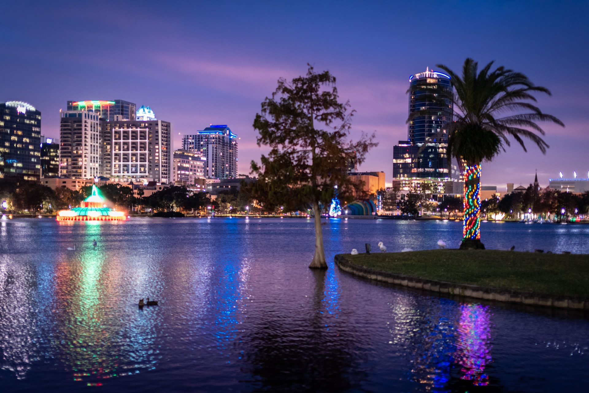 Downtown Orlando skyline at dusk across Lake Eola