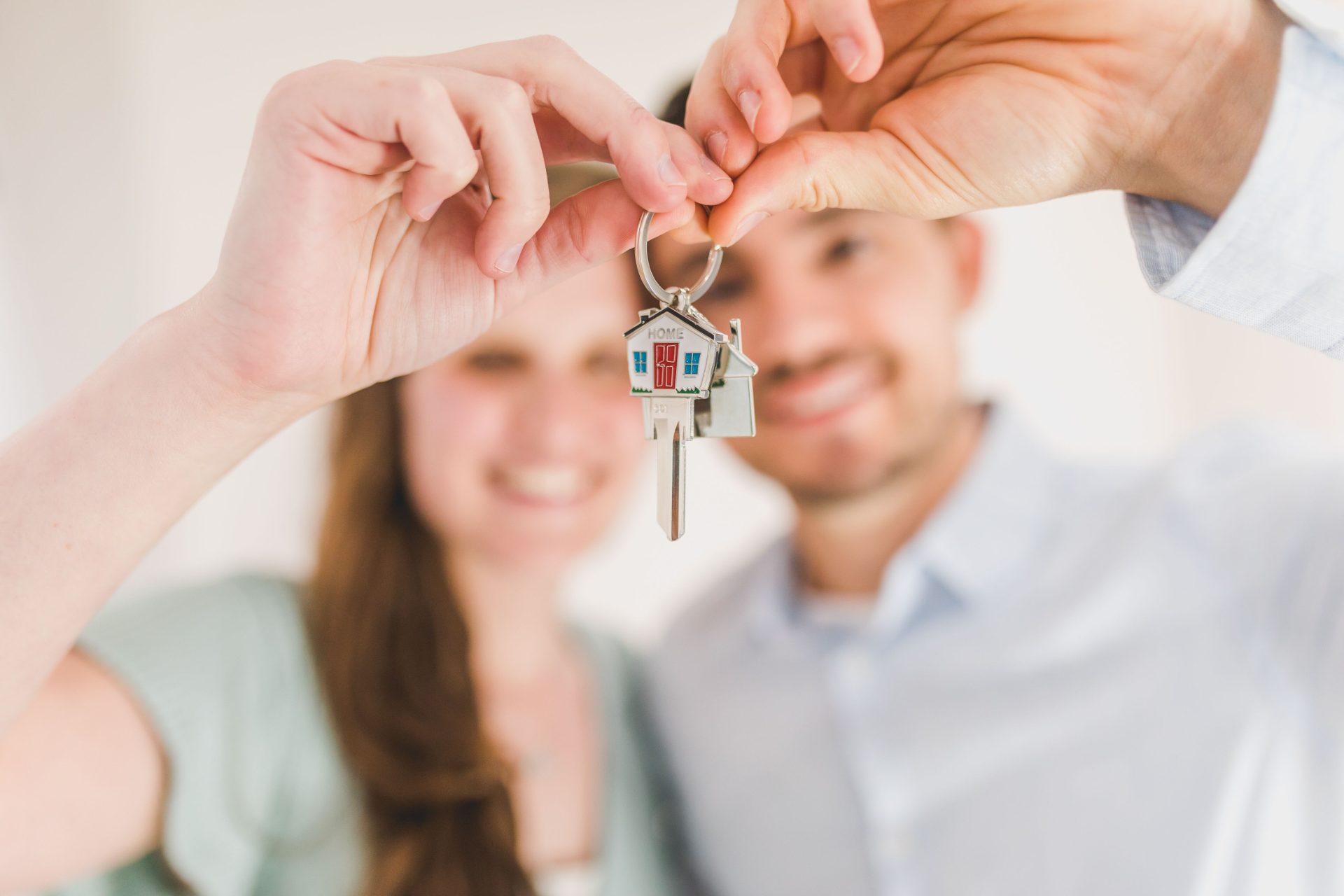 Couple holding up the keys to their new home